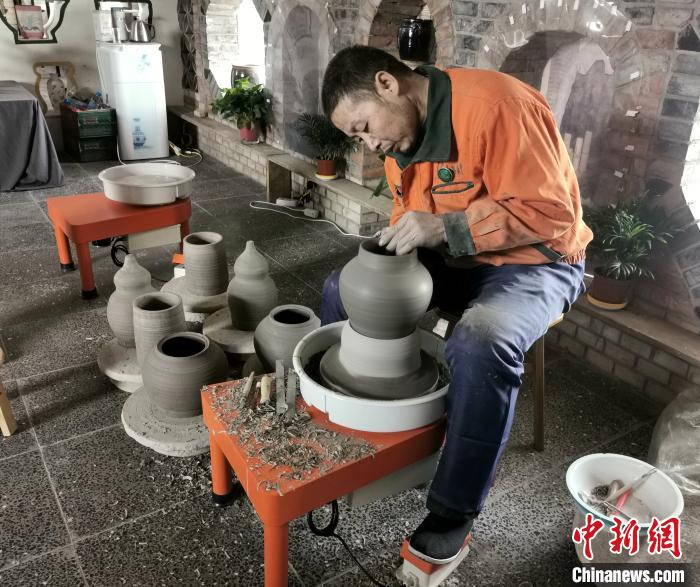 梁小板在陶瓷体验馆内忙碌着。　杨杰英 摄
